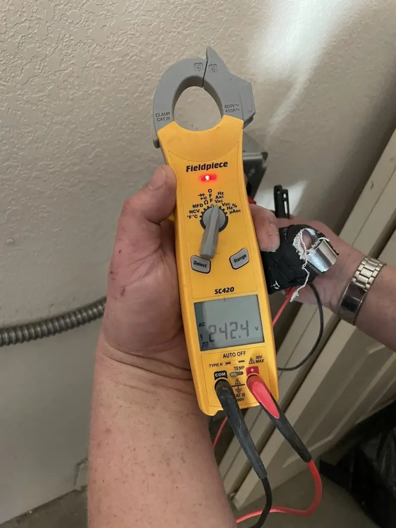 Voltage testing with clamp meter during Electrical Installation Services in Arbutus